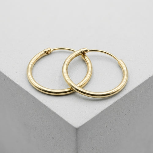 Hoop earrings — Minimalist Studio Packshot | Generated by Modelize